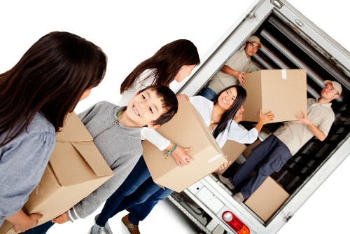 Moving team handling flat removals in Knightsbridge near a luxury apartment building