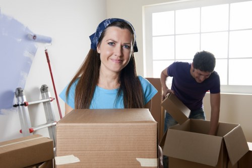 Trained removals staff handling furniture carefully during loading