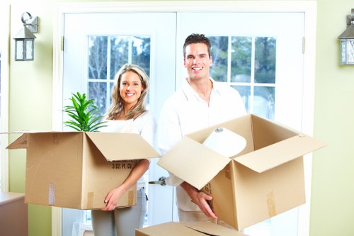 Mover carrying wrapped furniture near Knightsbridge properties