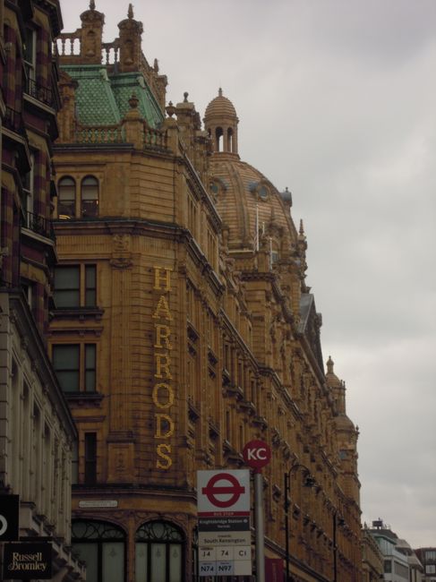 A close-up view of a street sign on a beige stone building indicating Serle Street, WC2, in the City of Westminster. The sign is mounted on the wall near a window, with the shadow of the building cast
